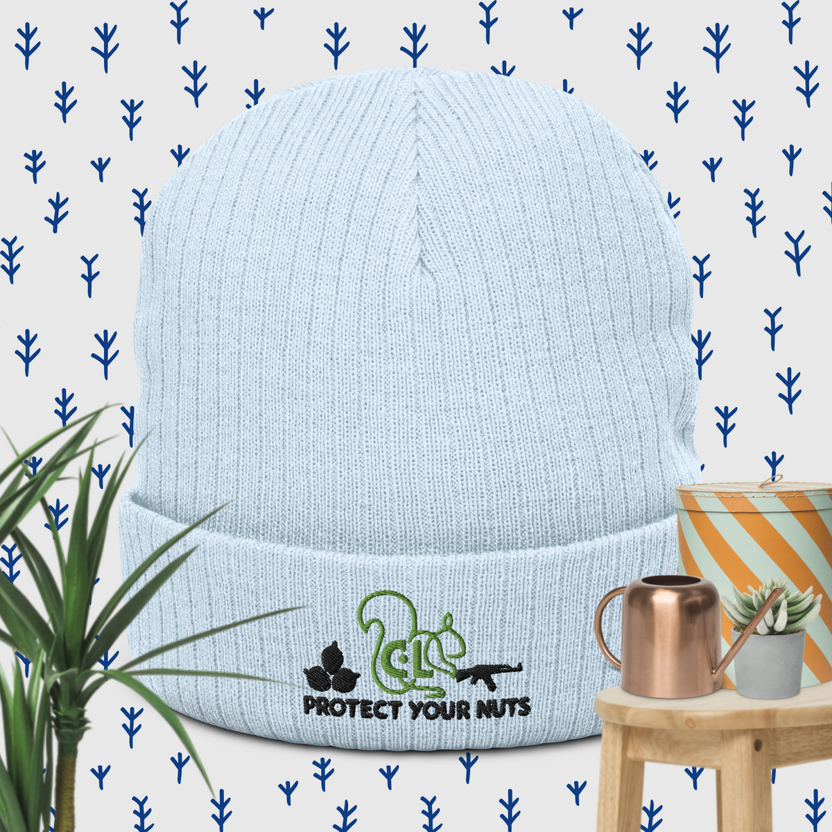 Pale blue Protect Your Nuts ribbed beanie, front view with green squirrel and black slogan embroidery.