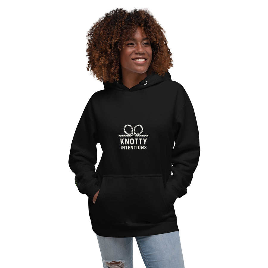 Model wearing a black KI hoodie, front view with white rope logo.